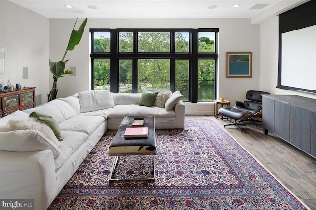 living area with visible vents, recessed lighting, and wood finished floors