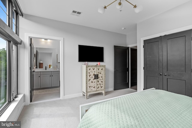 bedroom with baseboards, visible vents, a closet, light carpet, and connected bathroom