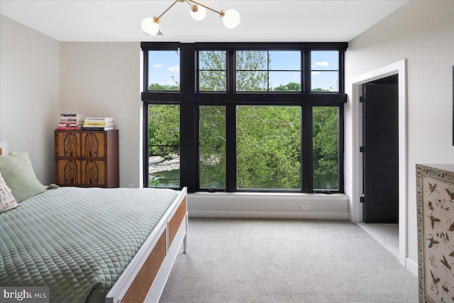 unfurnished bedroom with carpet flooring and an inviting chandelier