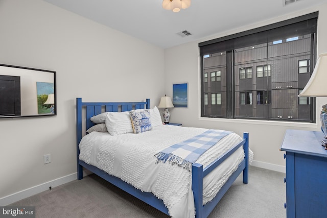 carpeted bedroom with visible vents and baseboards