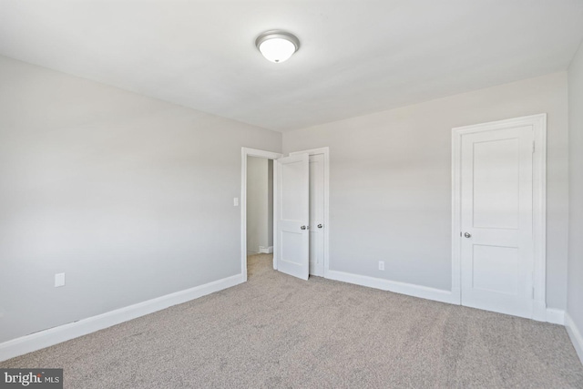 empty room with baseboards and carpet floors