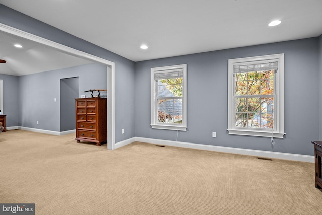 unfurnished bedroom featuring visible vents, recessed lighting, light colored carpet, and baseboards