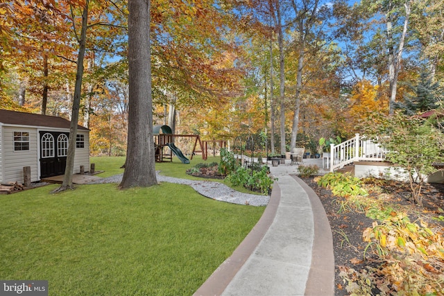 view of yard with an outdoor structure and playground community