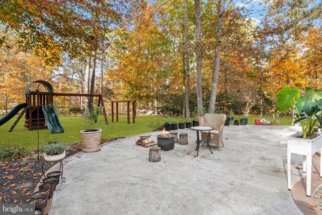 view of patio featuring a fire pit and a playground