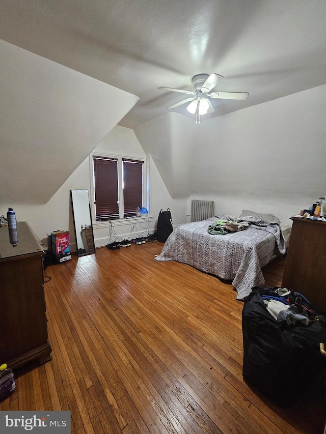 bedroom featuring wood-type flooring, lofted ceiling, and a ceiling fan