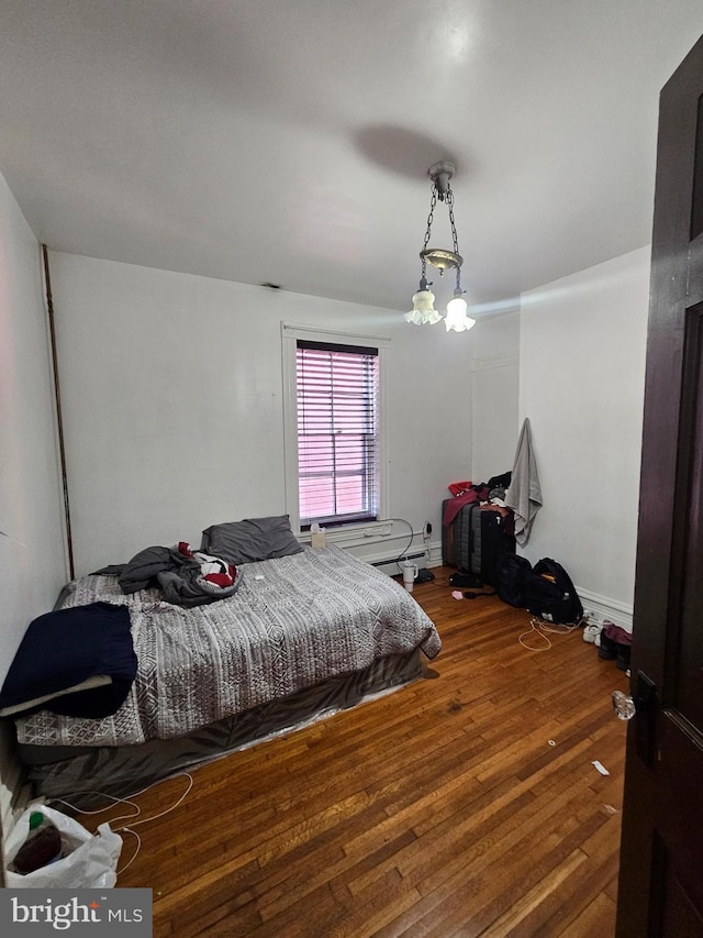 bedroom with hardwood / wood-style flooring