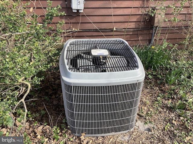 exterior details with brick siding and central AC unit