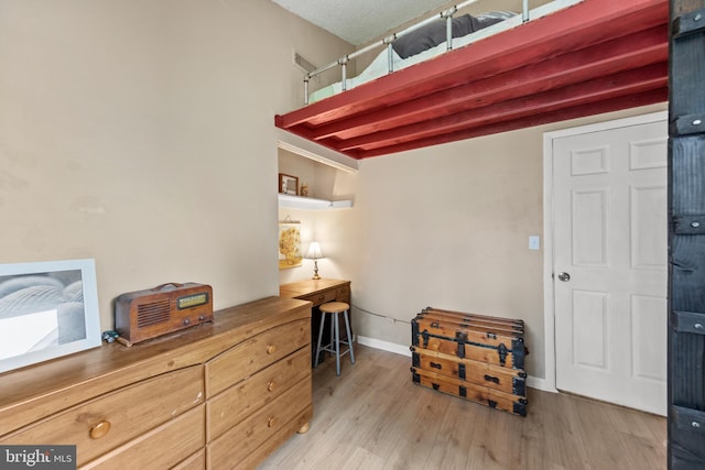 bedroom with baseboards and light wood-style floors