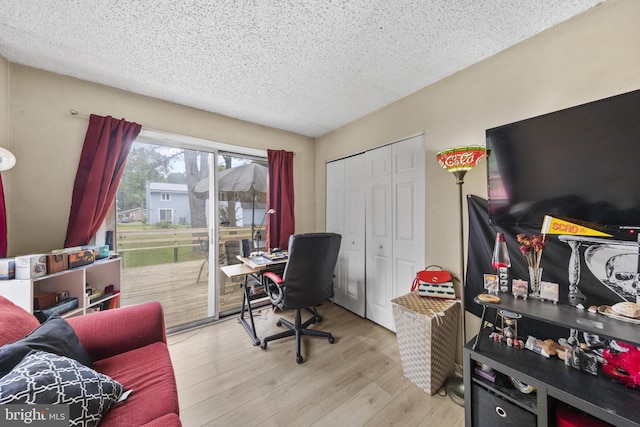 office space with a textured ceiling and wood finished floors