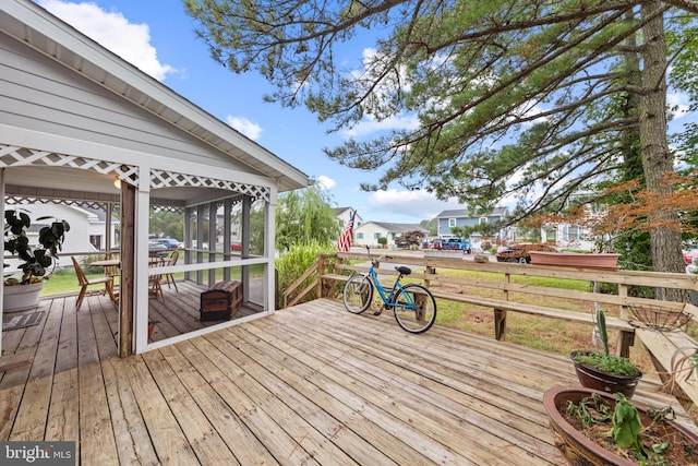 wooden terrace with a residential view and a sunroom