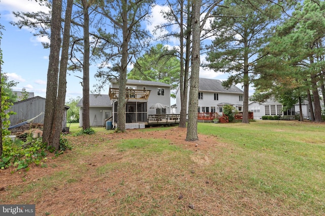 view of yard featuring a deck and a sunroom