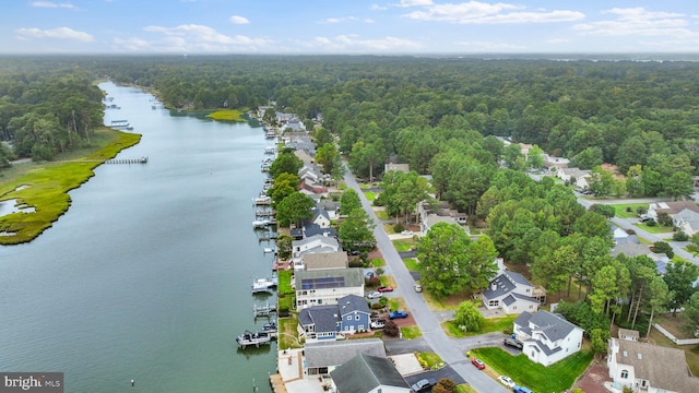 birds eye view of property featuring a residential view, a forest view, and a water view