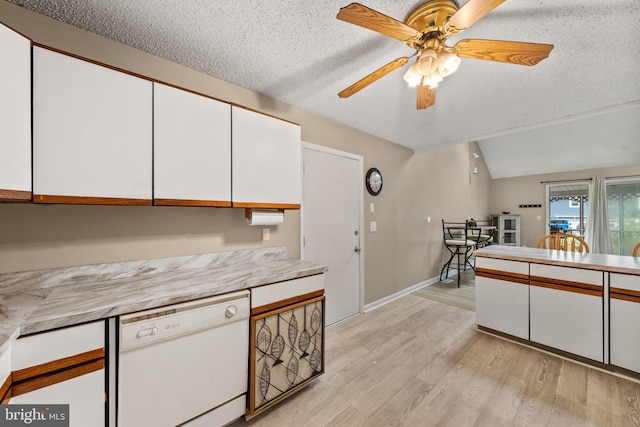 kitchen with white cabinetry, light countertops, white dishwasher, and light wood-type flooring