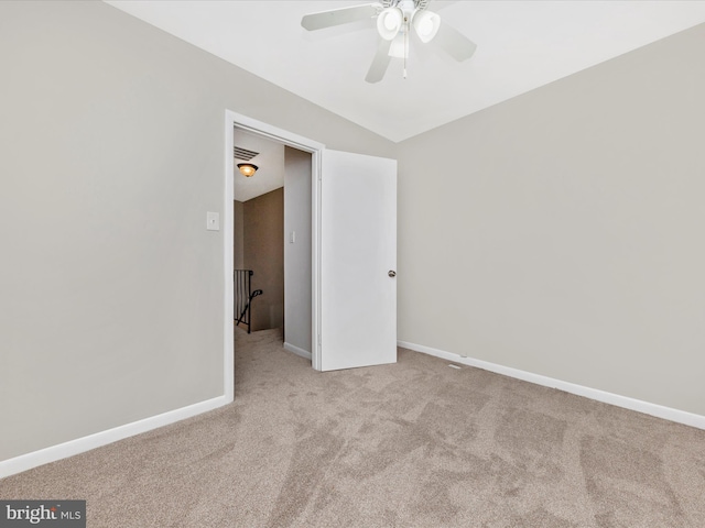 carpeted empty room featuring visible vents, ceiling fan, and baseboards