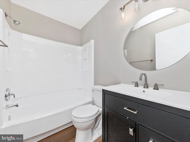 bathroom featuring tub / shower combination, toilet, vanity, and wood finished floors