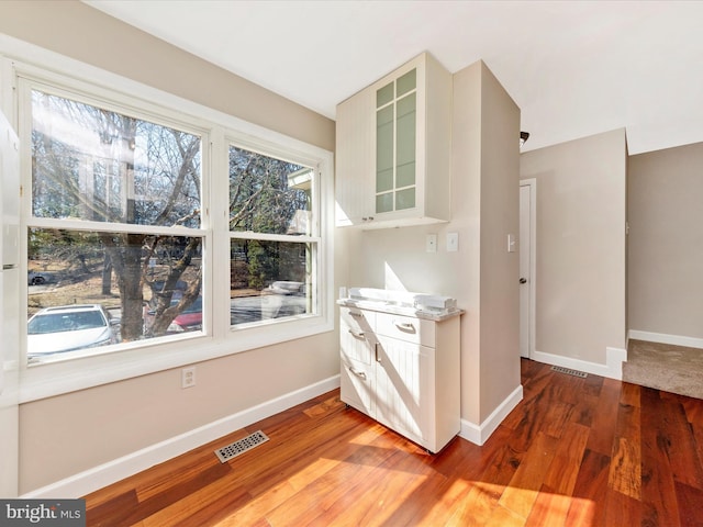 interior space featuring visible vents, baseboards, and light wood finished floors