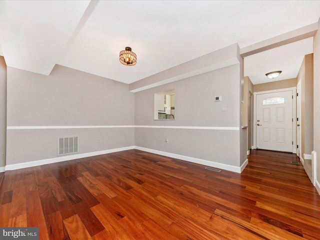 interior space with visible vents, baseboards, and wood finished floors