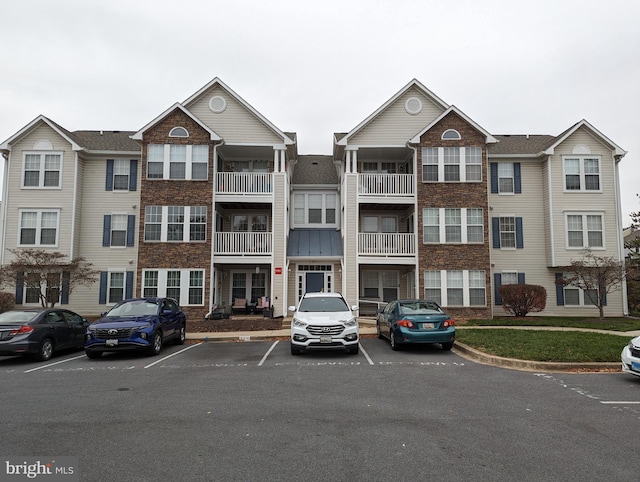 view of building exterior featuring uncovered parking