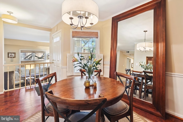 dining room featuring a healthy amount of sunlight, an inviting chandelier, and wood finished floors