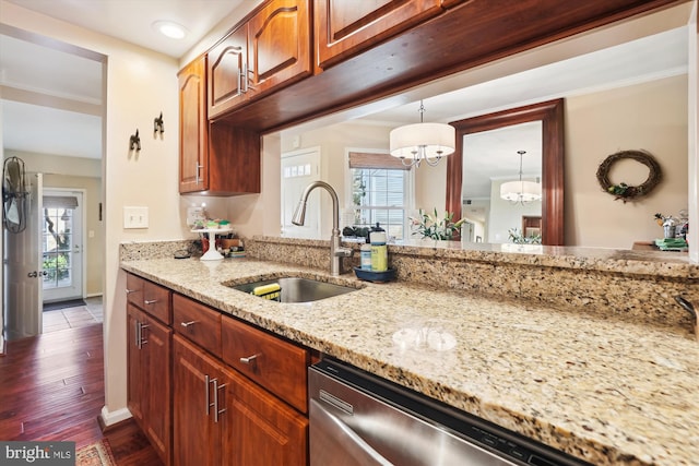 kitchen featuring dark wood-type flooring, a sink, light stone counters, stainless steel dishwasher, and a chandelier