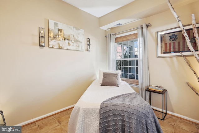 bedroom featuring visible vents and baseboards