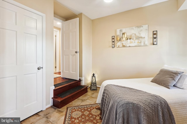 tiled bedroom featuring baseboards