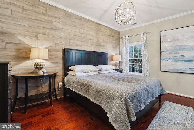 bedroom featuring a notable chandelier, crown molding, baseboards, and wood finished floors