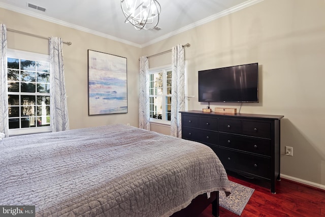 bedroom with visible vents, wood finished floors, crown molding, and a chandelier