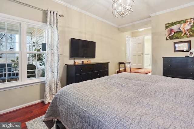 bedroom with wood finished floors, connected bathroom, an inviting chandelier, crown molding, and baseboards