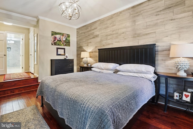 bedroom with an inviting chandelier, hardwood / wood-style flooring, and crown molding