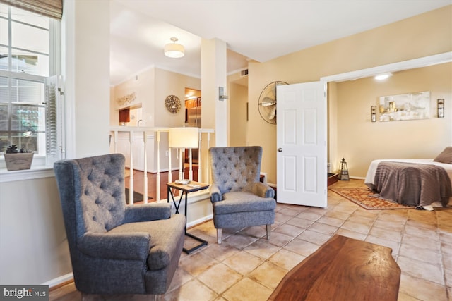 living area with tile patterned floors, a healthy amount of sunlight, and baseboards