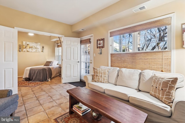 living area with light tile patterned flooring and visible vents