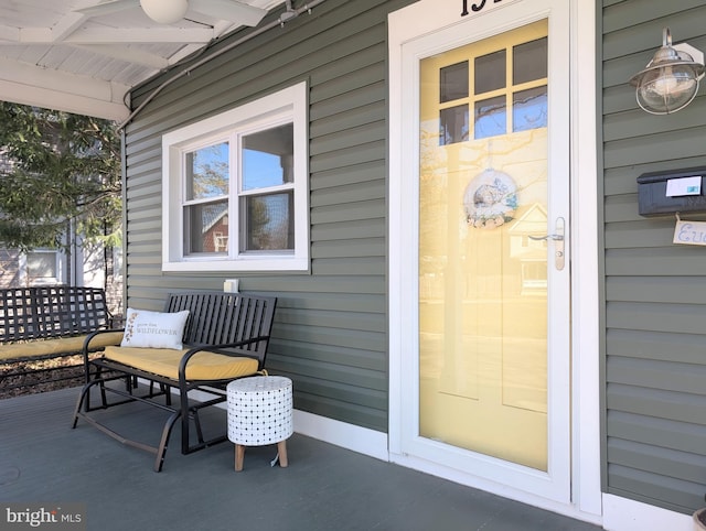 view of exterior entry featuring covered porch