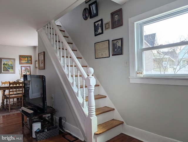 stairs with wood finished floors and baseboards