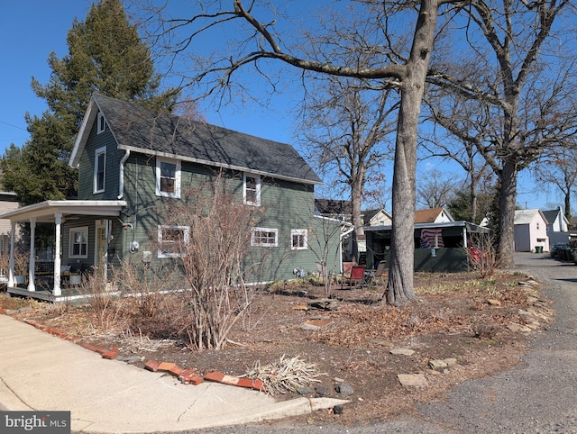 view of side of property featuring a porch