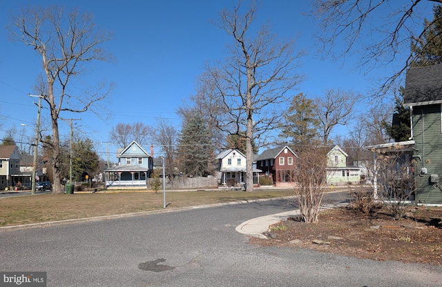 view of road with curbs and a residential view