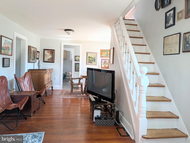 stairway with baseboards and wood finished floors