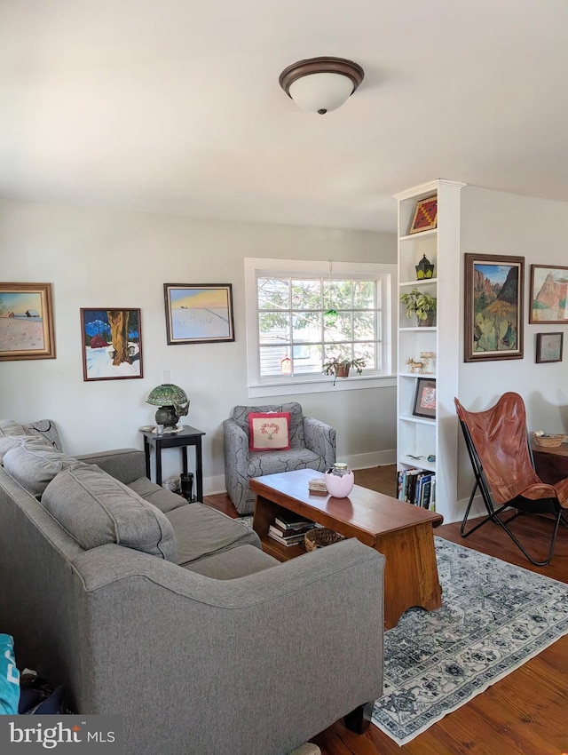 living room with baseboards and wood finished floors