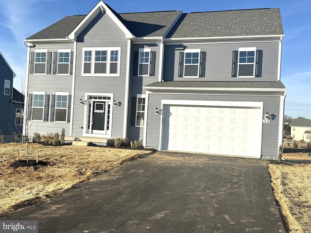 view of front of property featuring an attached garage and driveway