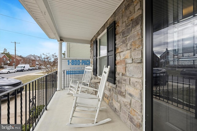 balcony with a residential view and a porch