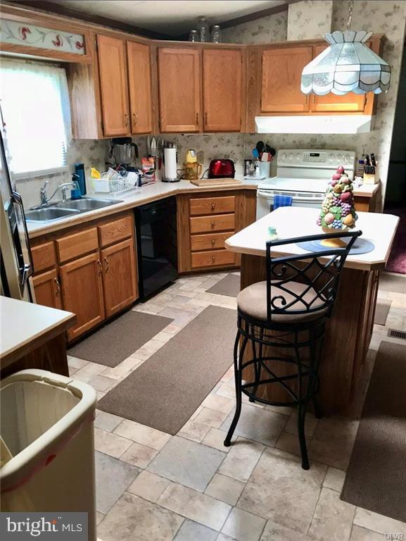 kitchen featuring brown cabinets, electric stove, a sink, light countertops, and dishwasher