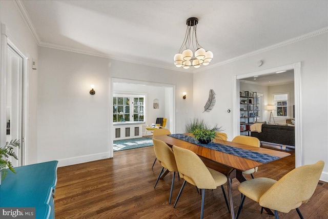 dining area with crown molding, wood finished floors, baseboards, and a chandelier