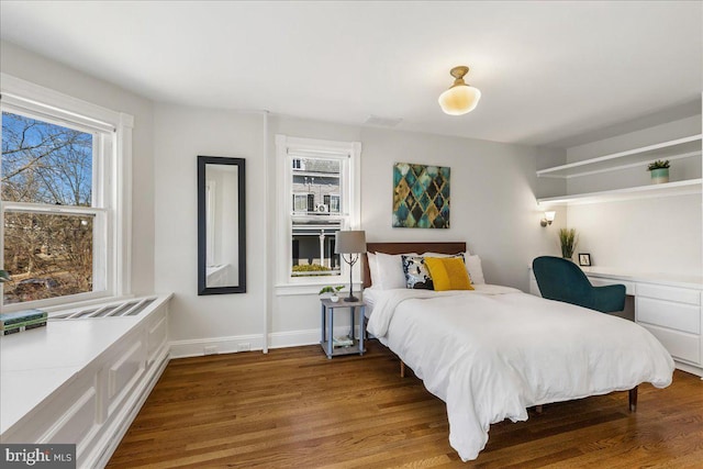 bedroom with baseboards and wood finished floors