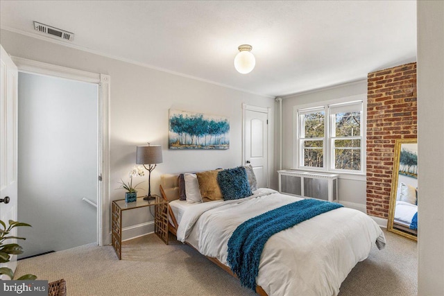 carpeted bedroom featuring radiator heating unit, baseboards, and visible vents