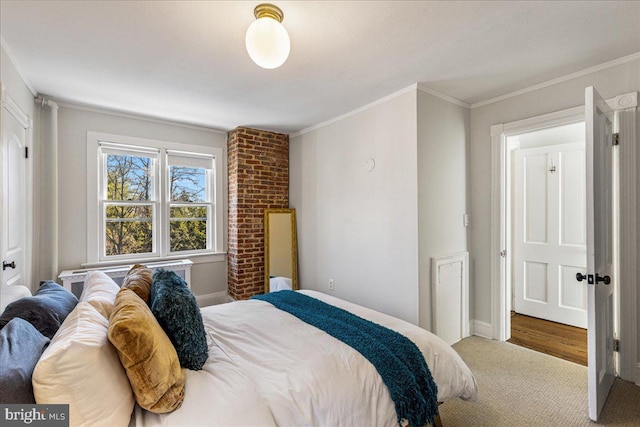 carpeted bedroom featuring crown molding and baseboards