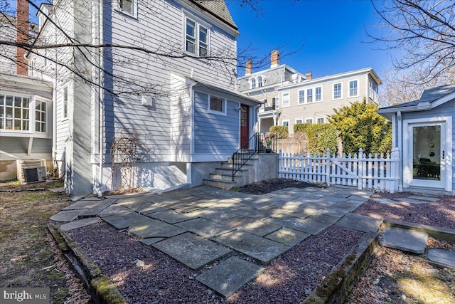 exterior space featuring fence and central AC