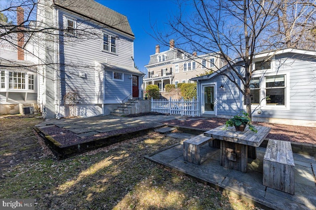 view of yard with a patio, central AC unit, and fence