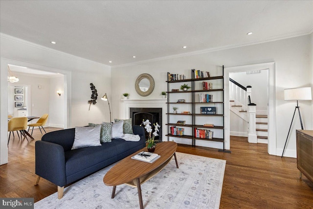 living area featuring stairs, recessed lighting, wood finished floors, and ornamental molding