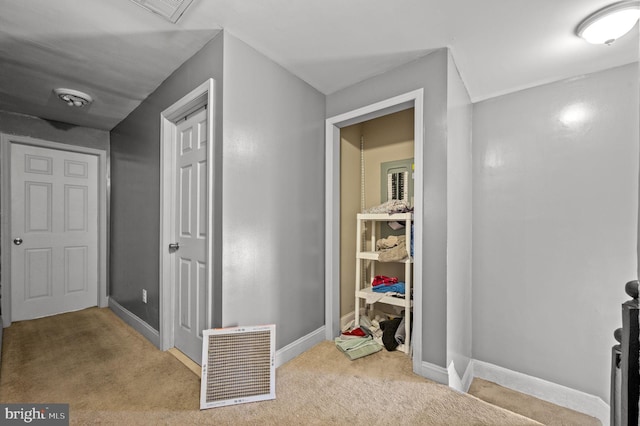 corridor with carpet flooring, baseboards, and visible vents