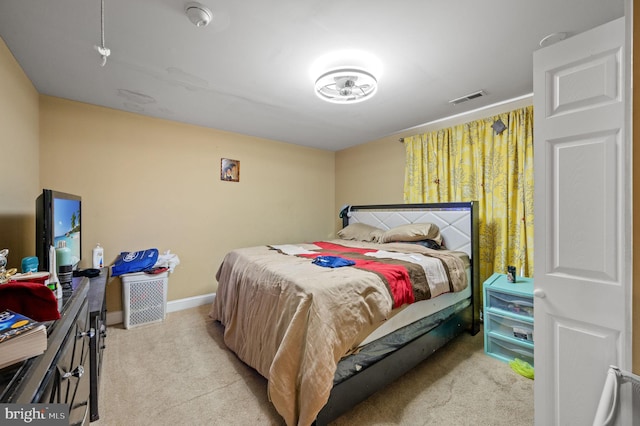 bedroom with light colored carpet, visible vents, and baseboards